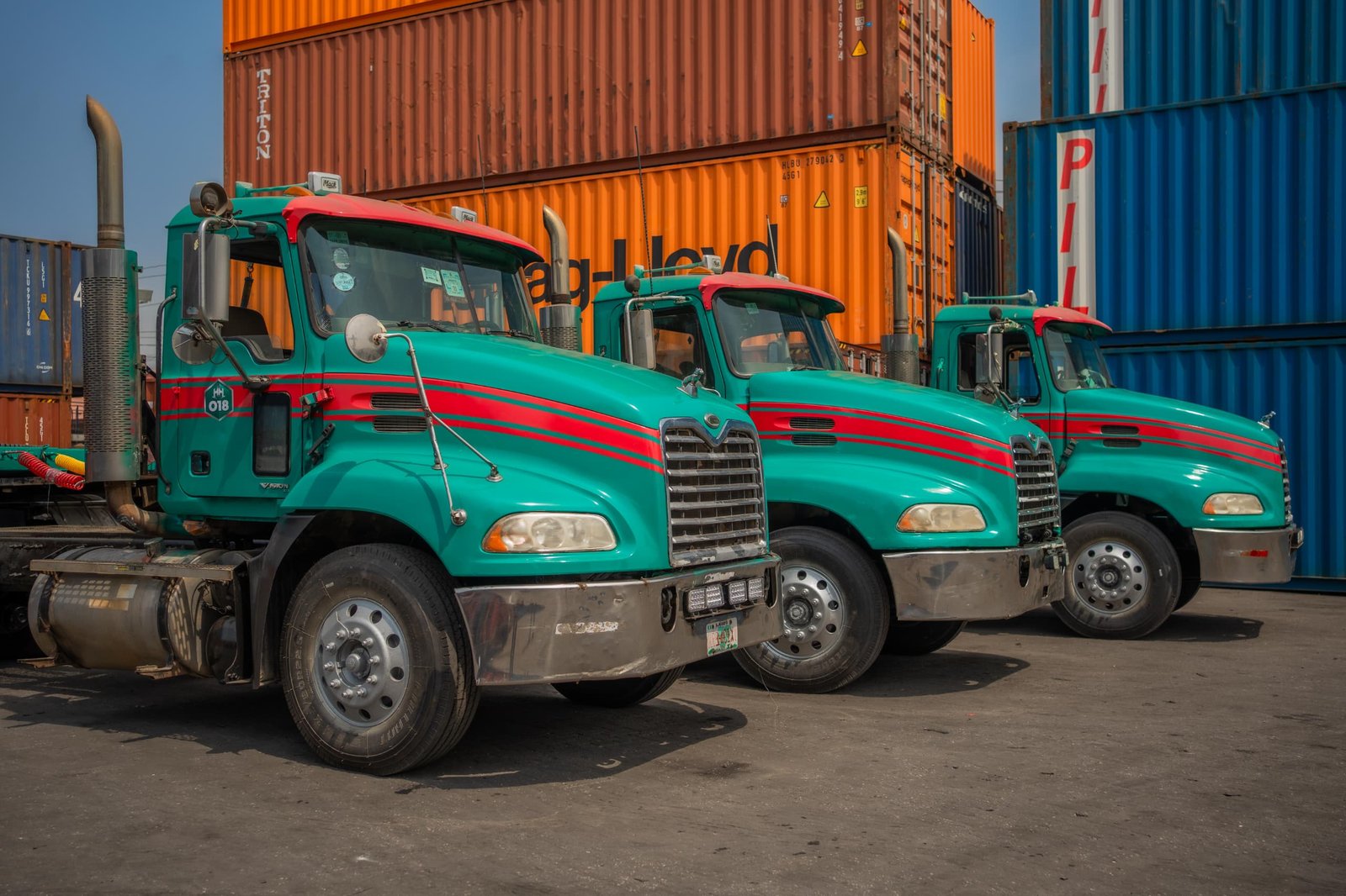 Hezegovin truck fleet lined up beside stacked containers at the Lagos terminal